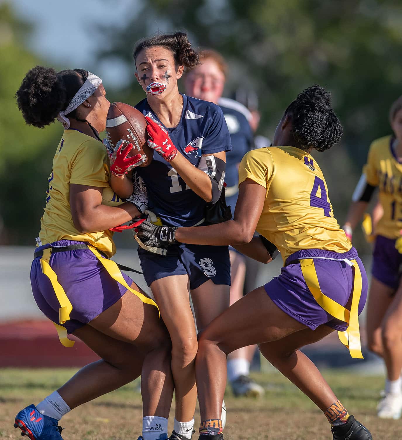 Springstead High’s ,17, Kandace Hanshaw has her progress stopped after catching a pass by Hernando High’s ,7, Shane Rayford and 4, Kayla Holloman Monday at Booster Stadium. Photo by JOE DiCRISTOFALO