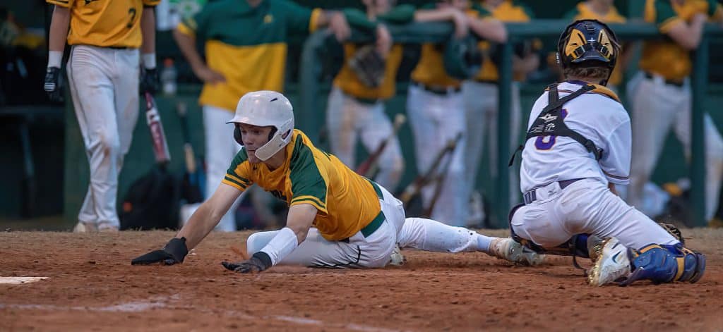 Lecnto runner scores just ahead of the tag attempt by Hernando catcher Drew Bittenger Friday in Brooksville. Photo by JOE DiCRISTOFALO