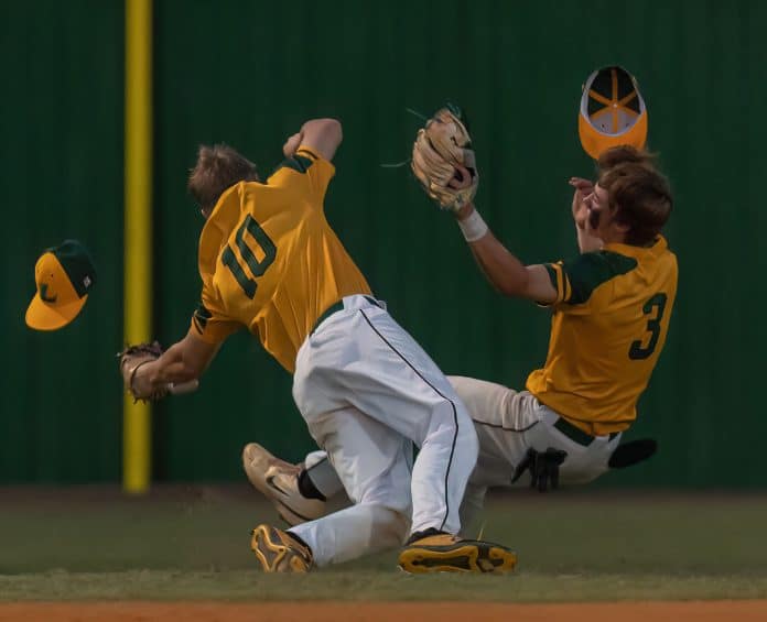 Lecanto High’s Drew Czerwinski and Kamden Aungst collided while catching a pop fly Friday evening in the game at Hernando High. Photo by JOE DiCRISTOFALO.