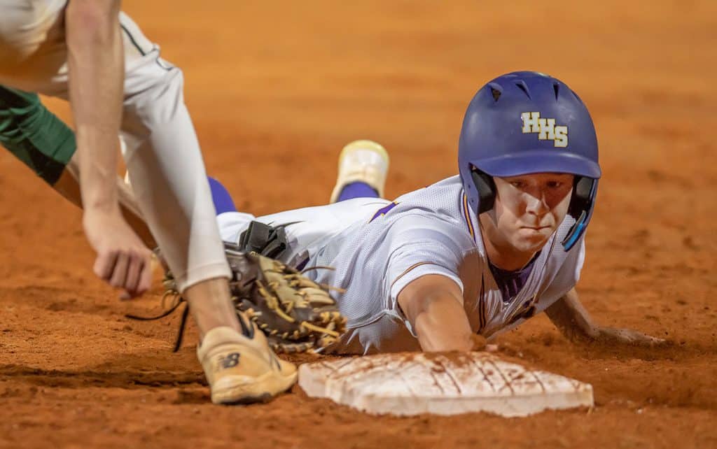 Hernando High’s Drew Vanalstine gets back to first base to avoid being picked off in the game against visiting Lecanto High Friday in Brooksville. Vanalstine later stole second and scored in the inning. Photo by JOE DiCRISTOFALO