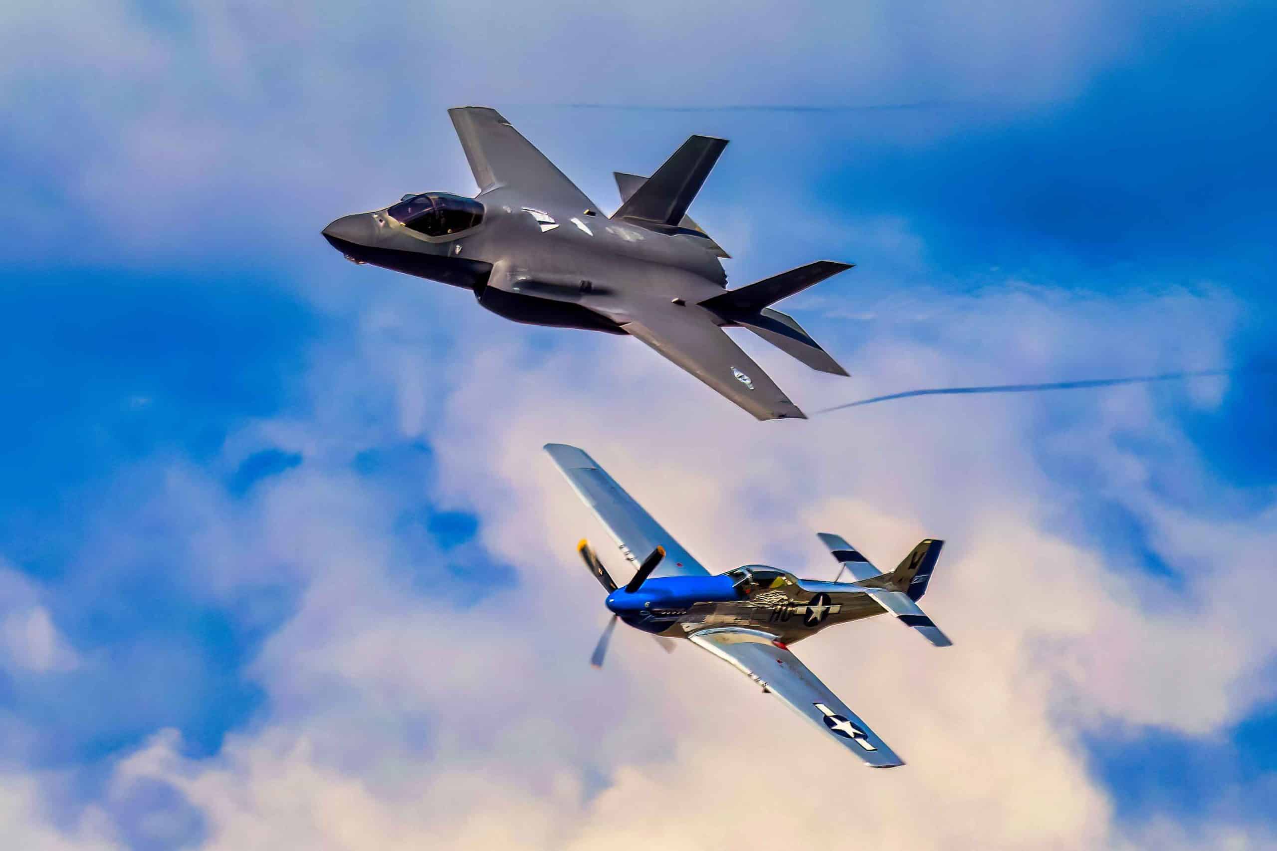 A US Air Force F-35A Lightning II flies formation with a WWII era P-51 Mustang in a tribute to veterans. Photo credit: Mark Stone