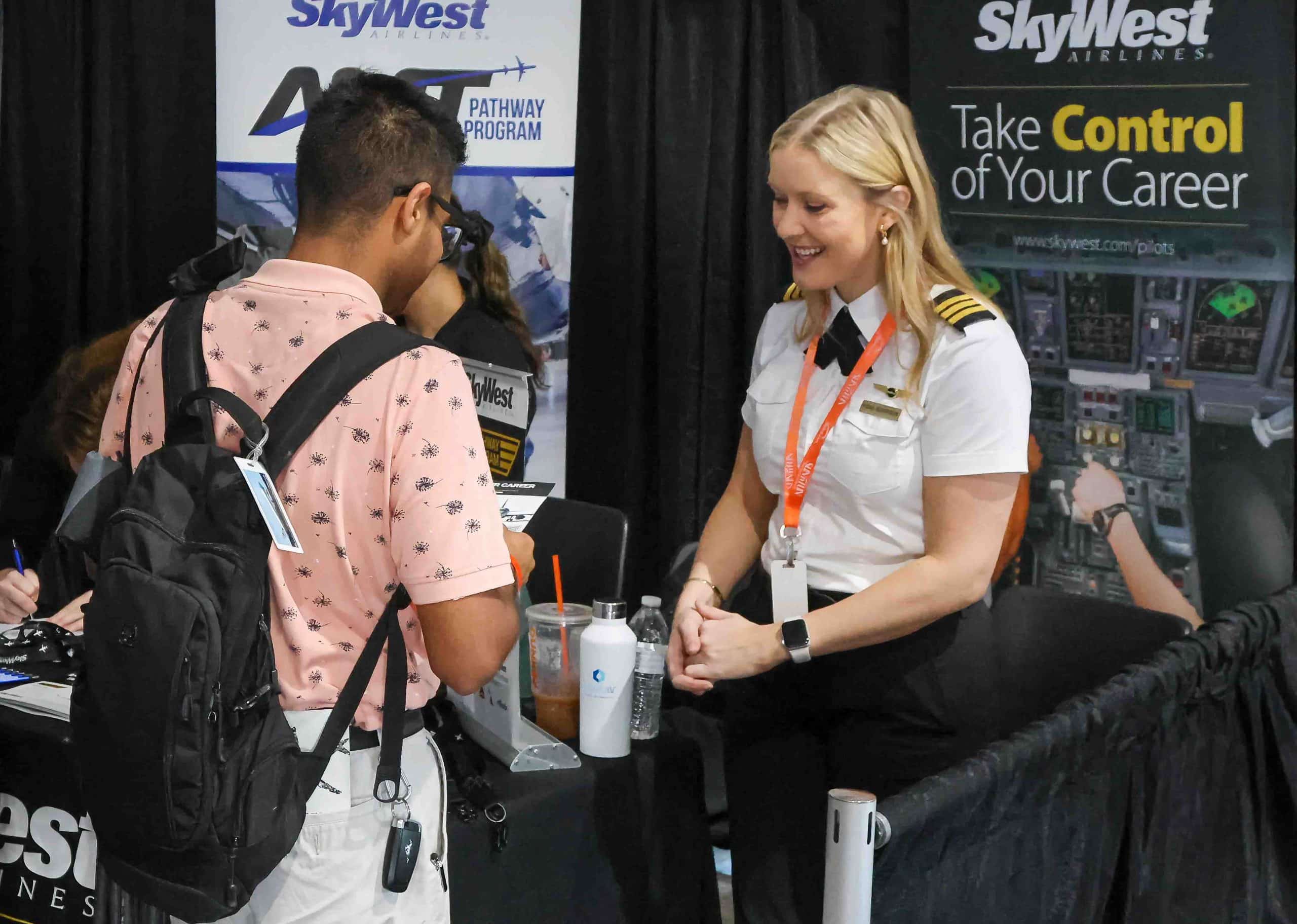 SkyWest Airlines First Officer Fiona Morrison discusses employment at SkyWest with a potential recruit. Photo credit: Mark Stone
