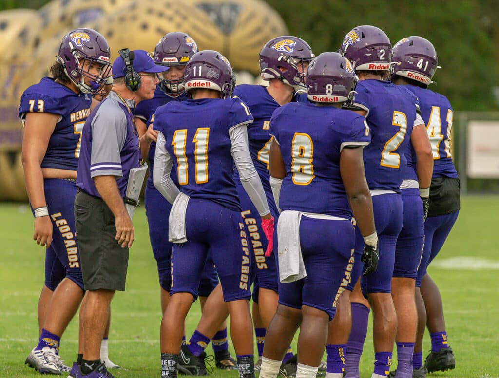 Hernando High Head Coach, John Scargle, addresses his team during a timeout in the game with Clearwater High. Photo by JOE DiCRISTOFALO 8/18/23