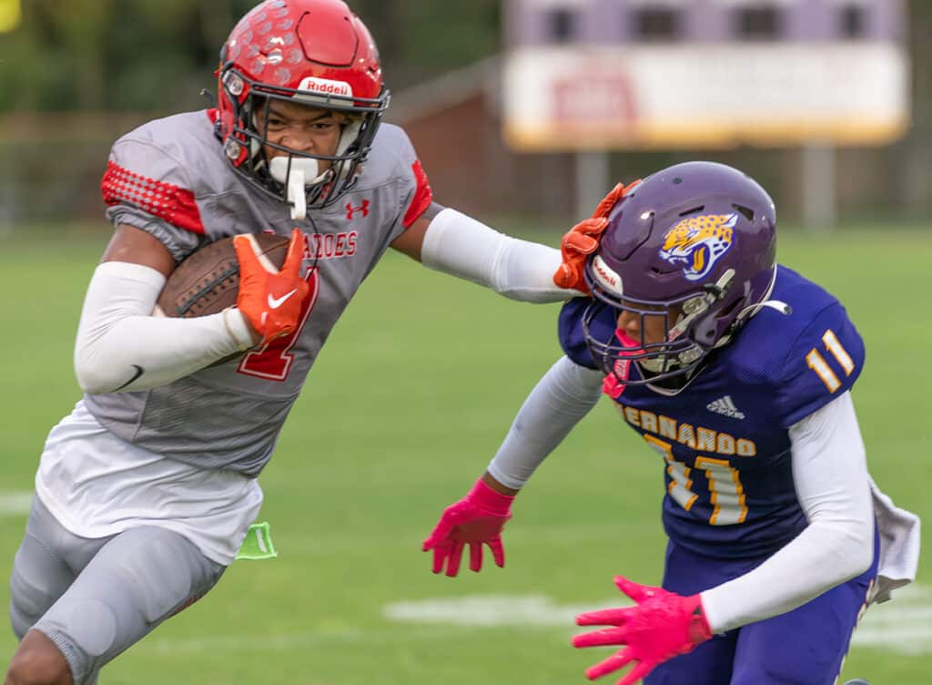 Hernando High, 11, Kamani Dotson tries to slow down Clearwater High’s, 1, Gage Nix Friday in Brooksville. Photo by JOE DiCRISTOFALO 8/18/23