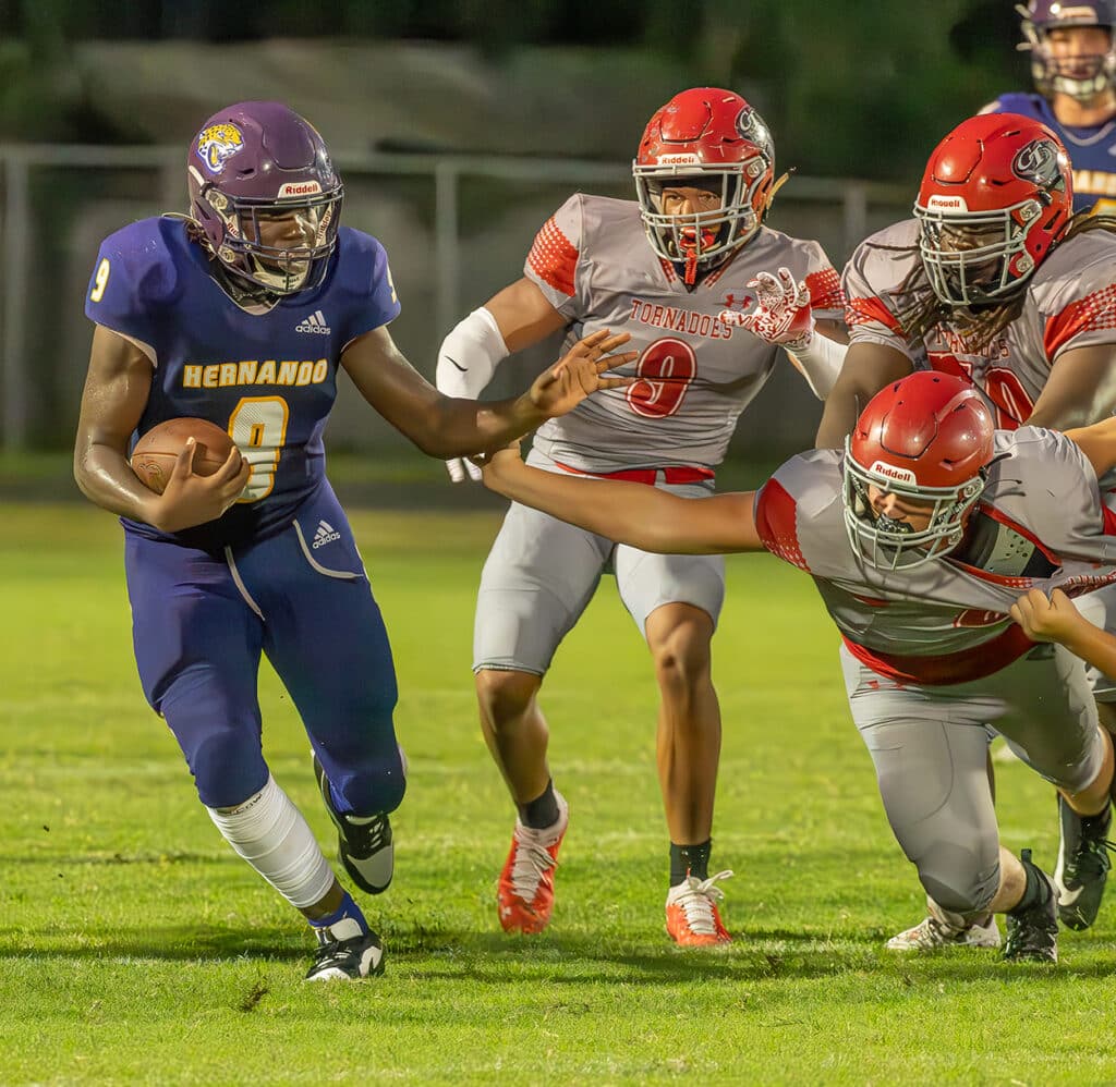 Hernando High’s ,9, John Capel III, looks to elude a bevy of Clearwater High defenders during Friday nights home preseason game. Photo by JOE DiCRISTOFALO