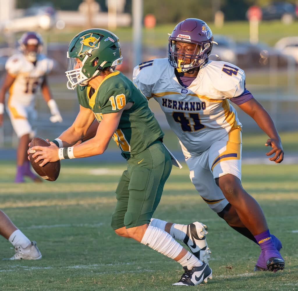 Hernando High’s, 41, Keaundre Gavin, looks to wrap up Lecanto QB, 10, J.T. Tipton Friday in Lecanto. Photo by Joe DiCristofalo.