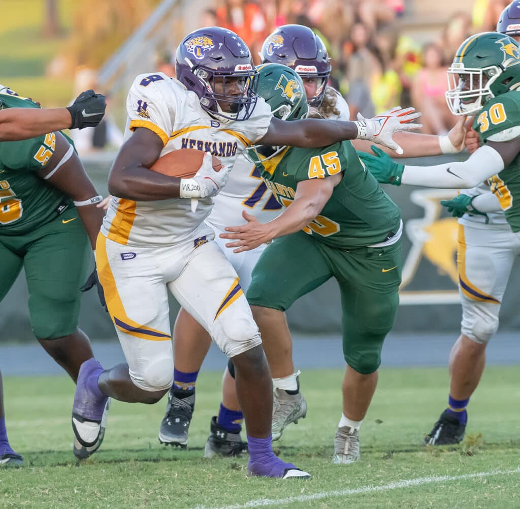 Hernando High’s, 9, John Capel III breaks through the line for a gain against the Panthers Friday in Lecanto. Photo by Joe DiCristofalo 9/22/23.