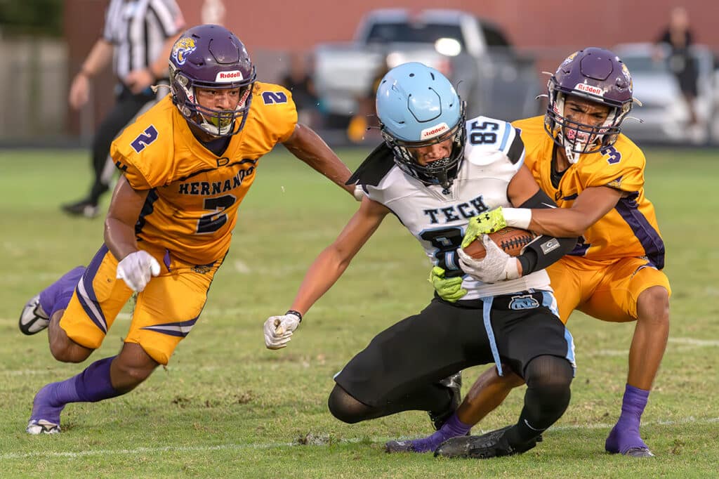 Nature Coast ,85, Gilbert Garcia has his progress stopped by Hernando High’s ,2, Gabe Sansone and Angel Garrestequi ,3, Friday in Brooksville. Photo by JOE DiCRISTOFALO