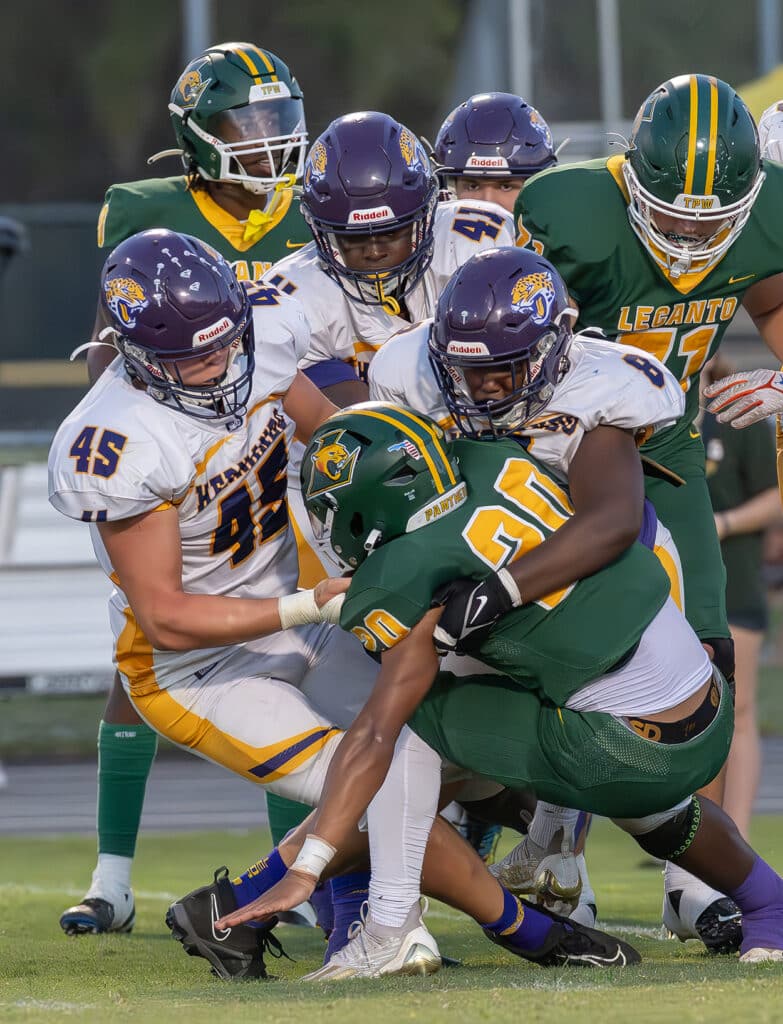 Hernando High defenders, 45, Colton Ashworth, 41, Keaundre Gavin and 8, Ezra Chester combine to stop a Lecanto High runner. Photo by Joe DiCristofalo 9/22/23.