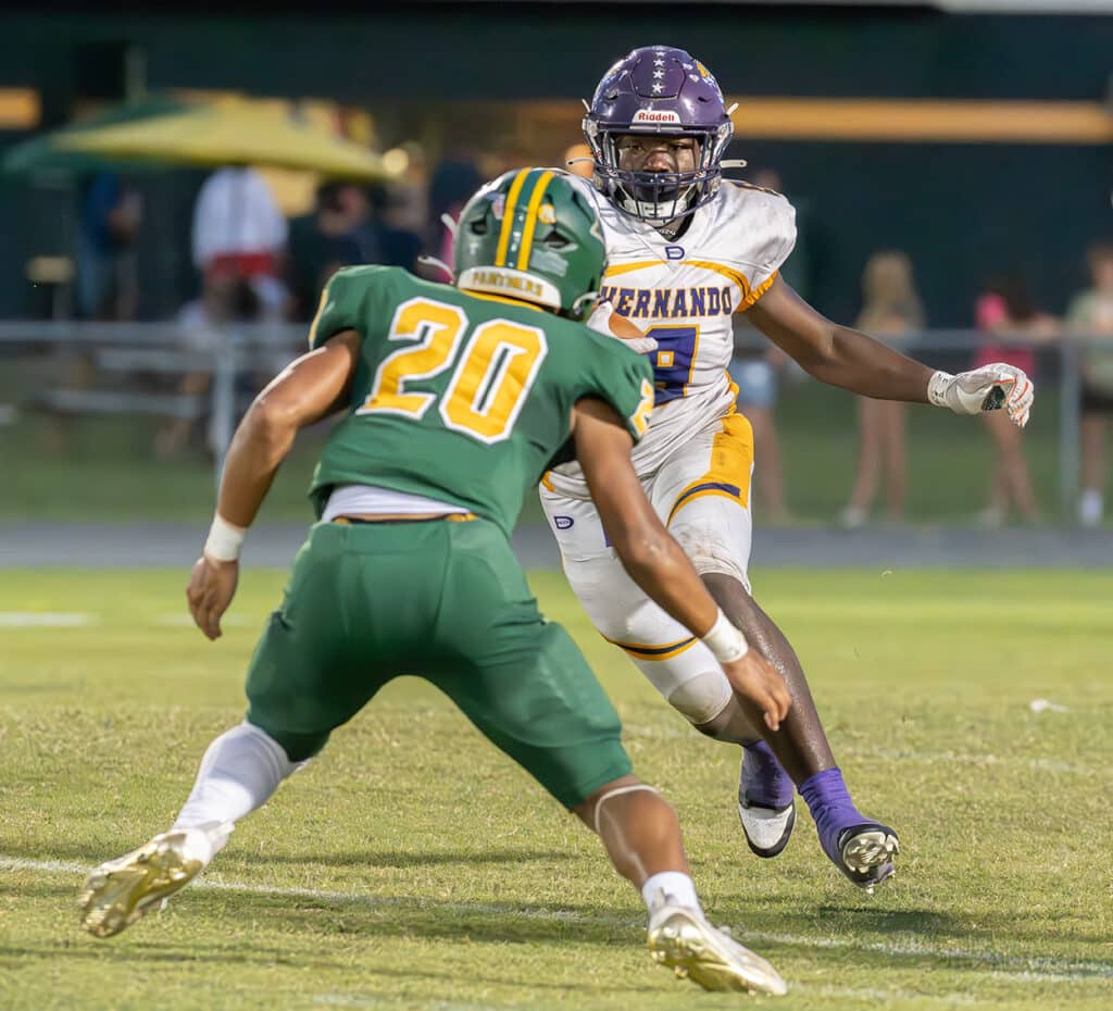Hernando High running back, 9, John Capel III sizes up a Lecanto High defender in the open field Friday in Citrus County. Photo by Joe DiCristofalo 9/22/23.