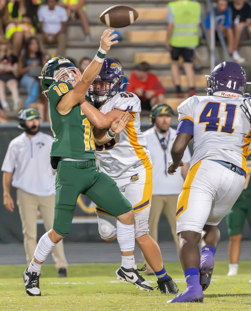 Hernando High’s 45, Colton Ashworth, disrupts a pass attempt by Lecanto High’s ,10, JT Tipton. The play resulted in an interception for the Leopards. Photo by Joe DiCristofalo 9/22/23.