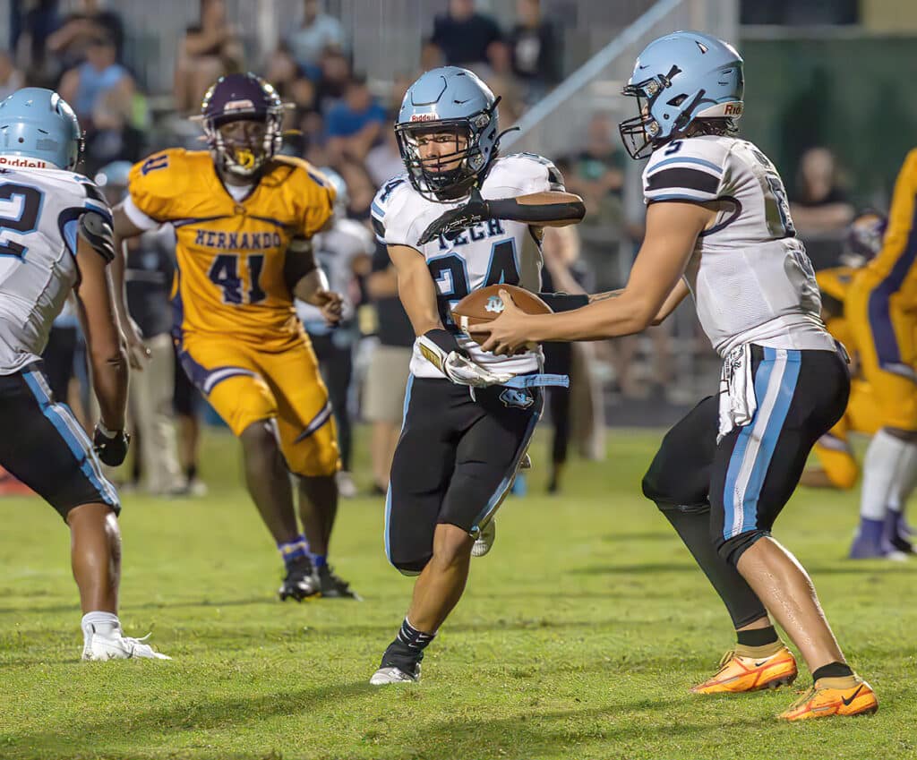 Nature Coast , quarter back, 5, Jackson Hoyt used this fake hand off to ,24, Cashis Williams before eluding the Hernando defense for a long gain. Photo by JOE DiCRISTOFALO