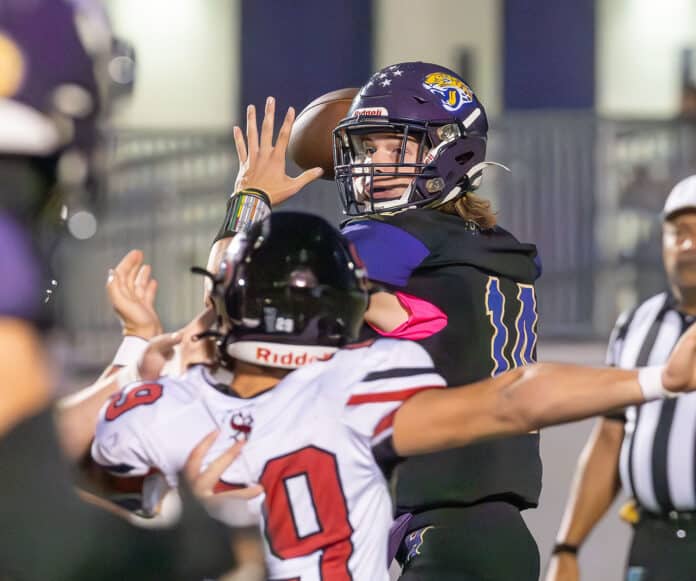 Hernando High QB, Michael Saltsman looks over the pressure by the South Sumter defense while attempting to complete a pass, 10/13/23. Photo by Joe DiCristofalo