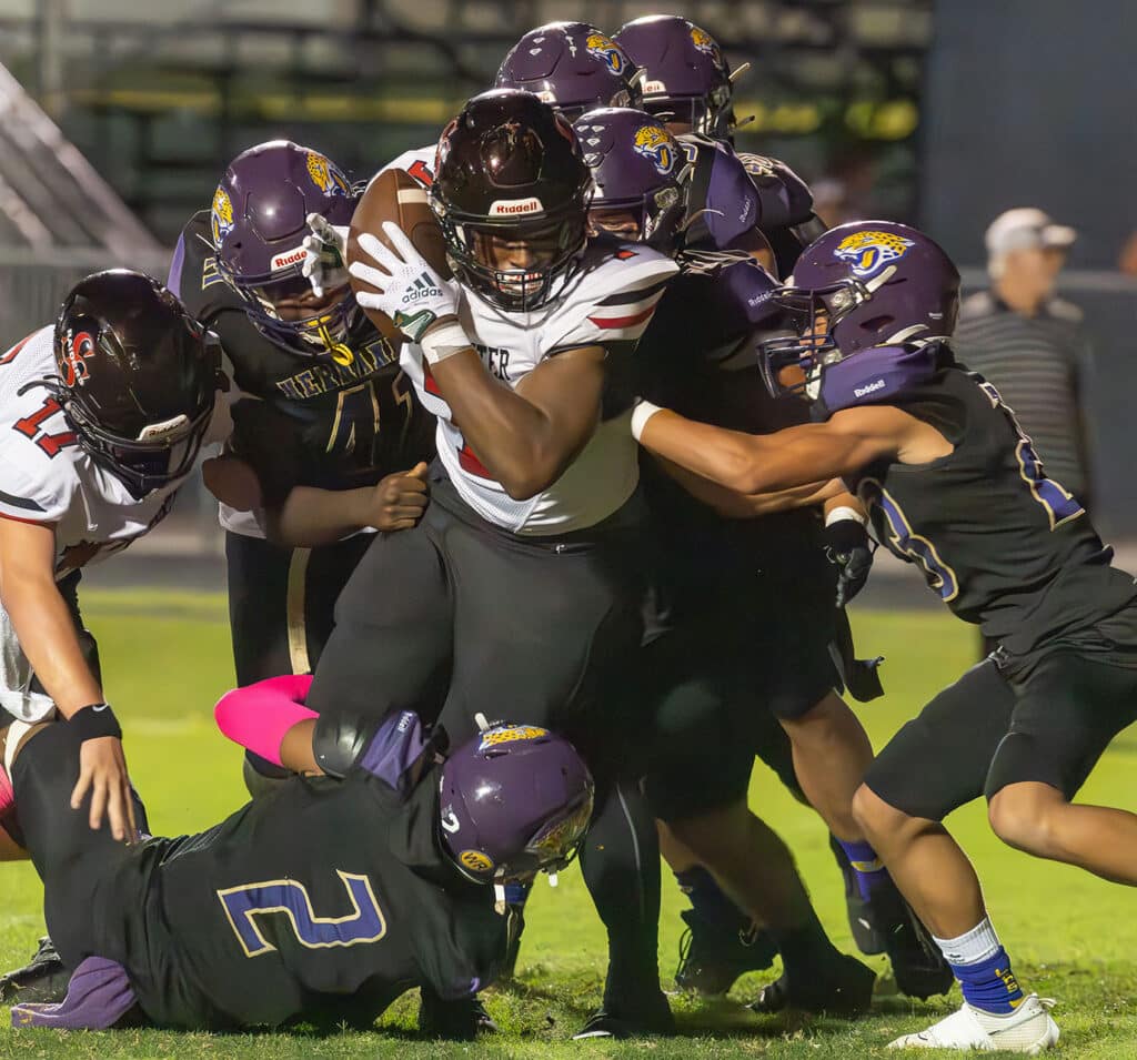 Members of the Hernando defense work to stop a South Sumter running back close to the goal line Friday night in Brooksville. Photo by Joe DiCristofalo