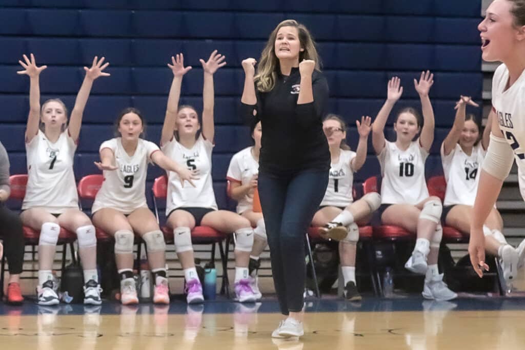 Monday night October 16,2023 at the Stead, coach Andrea Gracey is excited on a score from an intense volley against the Patriots in District playoffs. [Credit: Cheryl Clanton]