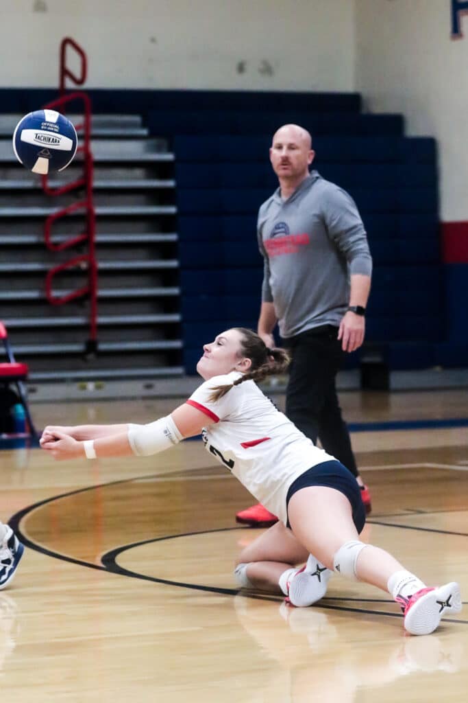 Monday night October 16,2023 at the Stead, Eagles #12 Sr. Emily Miller returns saved volley against the Patriots in District playoffs. [Credit: Cheryl Clanton]