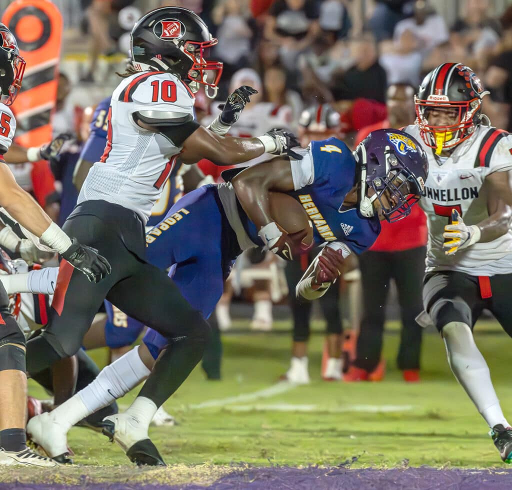 Hernando High, 4, Leandre Wright lunges for extra yardage against the stingy defense by visiting Dunnellon High. Photo by Joe DiCristofalo