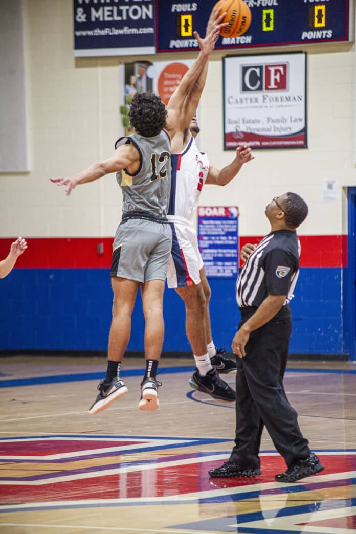 Springstead's Nick Cordero reaches for a jump ball, marking the start of the Springstead vs Sunlake basketball game. [Credit: Hanna Maglio]