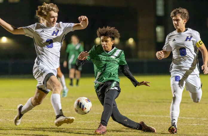 Weeki Wachee, 4 ,Adrian Dooley looses a shot between Hernando High’s , 3, Blake Miller and ,8, Cason Copeland . Photo by Joe DiCristofalo