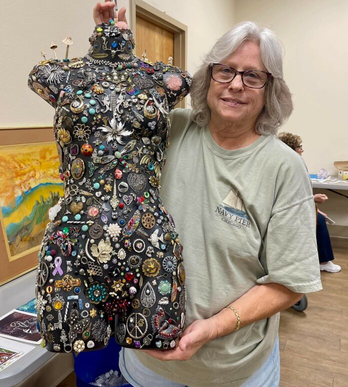 NCAL December Artist of the Month Carole Rose with her artwork. [Credit: Yolanda Barreto]