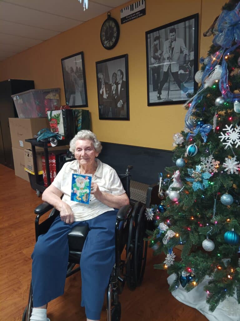 Ena, a Brooksville Healthcare Center resident, has discovered her love for art through the Nature Coast Art League Christmas Card project. [Credit: G. Valentin]