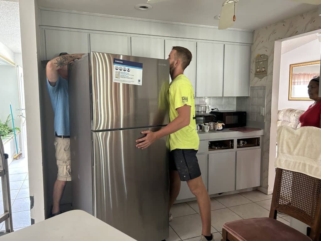 Installation of Robert Vannattans new refrigerator. [Photo provided by Maryann Gunn]