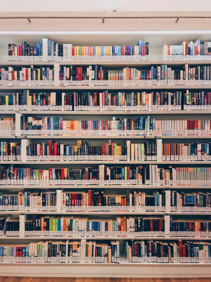 Bookshelf filled with books. Public domain photo from Unsplash.