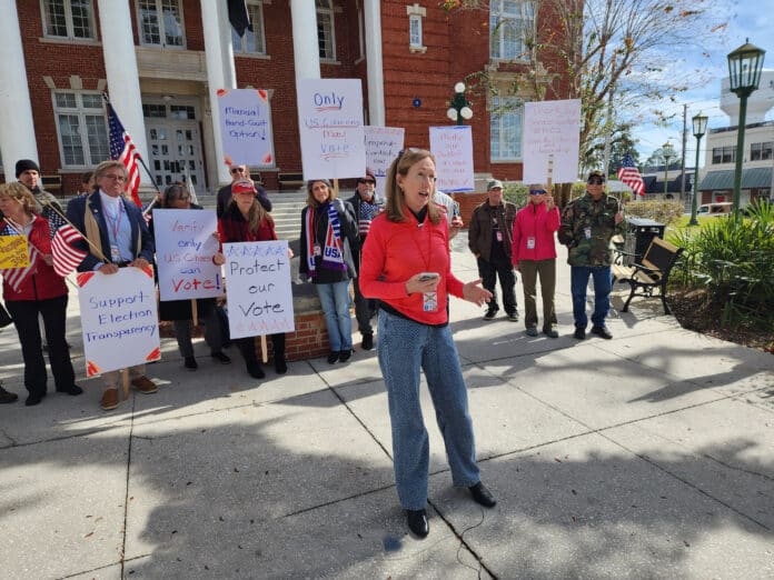 Kathleen Griffiths speaks about voting issues on the Courthouse Steps.