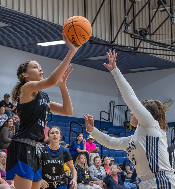 Hernando Christian Academy, 3, Briauna Richardson shoots the winning basket giving HCA a closely contested 23- 21 victory over Central High Friday night in Brooksville. Photo by Joe DiCristofalo