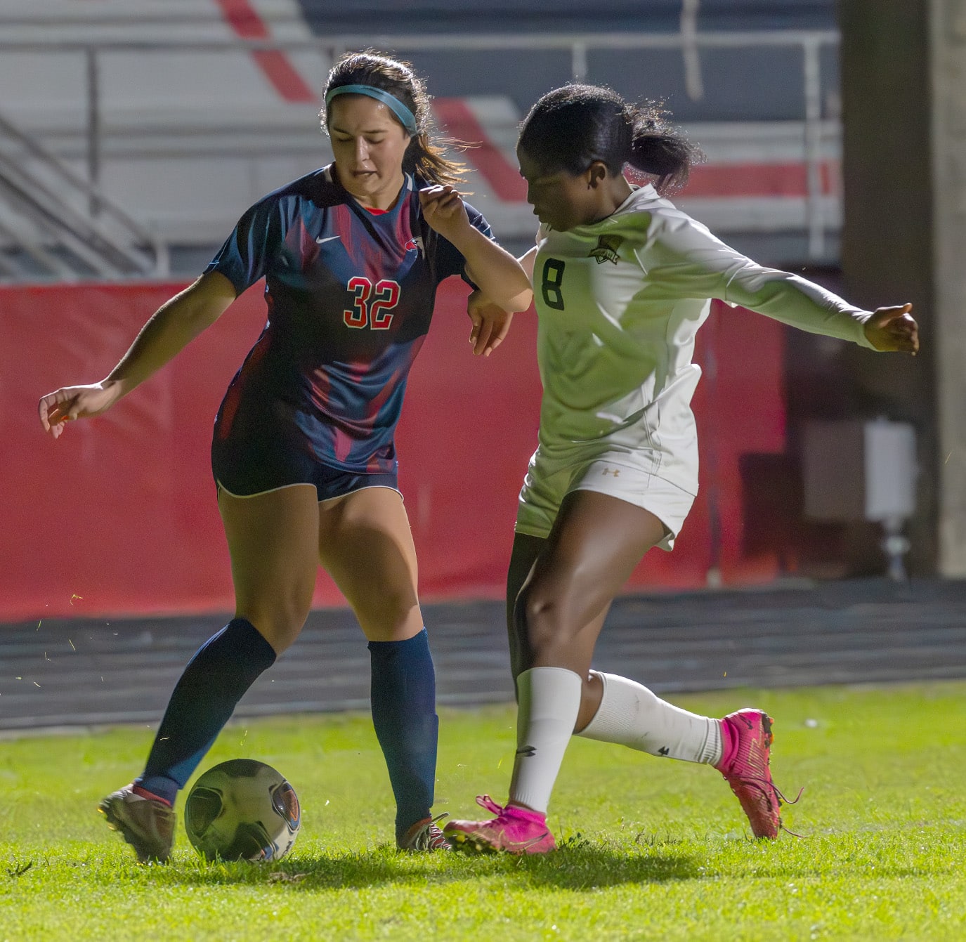 Springstead High, 32, Sidney Anderson possesses the ball while marked by Buchholz High defender, 8, Alisha Soults in the 6A District 4 semi-final game in Spring Hill. [Photo by Joe DiCristofalo]