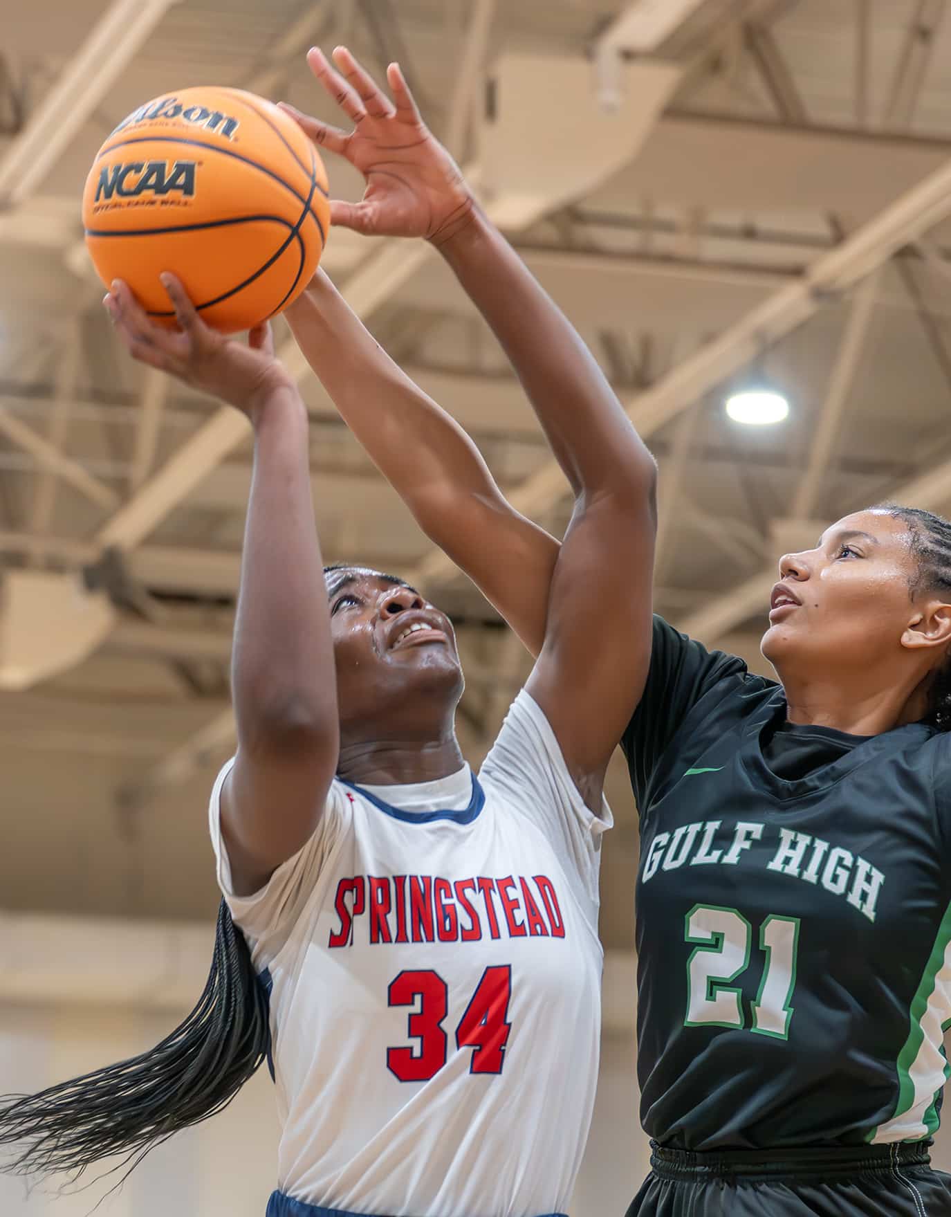 Springstead High, 34, Melanie Francis attempts a shot against Gulf High’s, 21, Ariana Rodriguez in the Springstead Holiday Tournament.[Credit: Joe DiCristofalo]