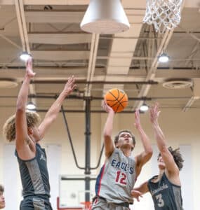 Springstead High’s, 12, Austin Nicholson shoots between Archbishop McCarthy defenders, 1, George Sterr and, 3, Andrew Sanchez in the semifinal match at the Glory Days Greg O’Connell Holiday Shootout. Photo by Joe DiCristofalo