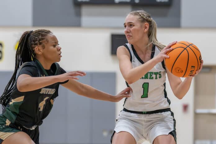 Weeki Wachee High’s ,1, Paige Atwater looks for a teammate under the basket during the game with visiting Villages Charter School. Photo by Joe DiCristofalo