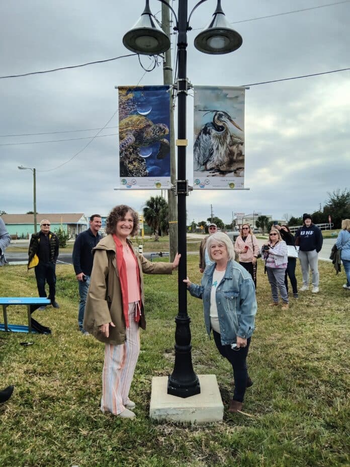 Victoria Yeager and Diane Ziemski stand proudly beside their banners. [Courtesy photo]