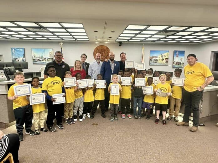 HYL 8U Football team with Brooksville City Council and coaches on Jan. 8, 2024. [Credit: City of Brooksville]