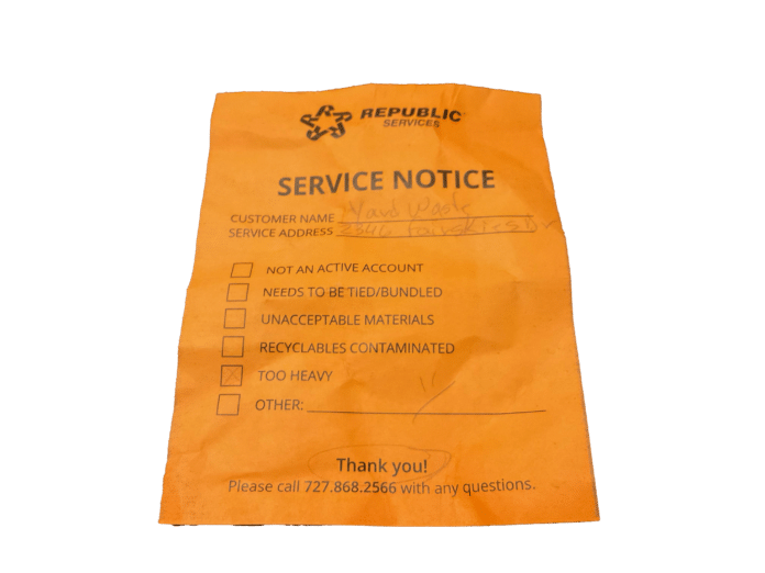 A service notice from Republic stating that the bundles of tree branches were too heavy for Republic to pick up.