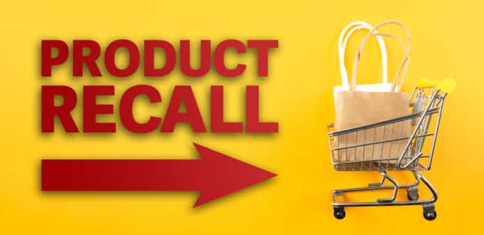 red text PRODUCT RECALL and arrow symbol against yellow background with shopping cart filled with shopping bags By Christian Horz