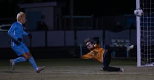 Nature Coast Tech, 7, Lothar Guzman watches as Weeki Wachee Goalkeeper, John Brooks makes a sensational save during Wednesday night’s 4A District 6 title game at NCT. [Photo by Joe DiCristofalo]