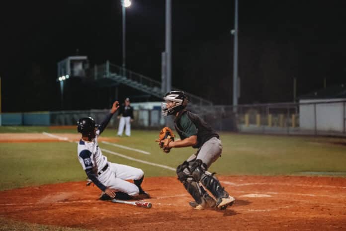 Central's Jayden Warren slides in to home base. Photo Credit: Cynthia Leota