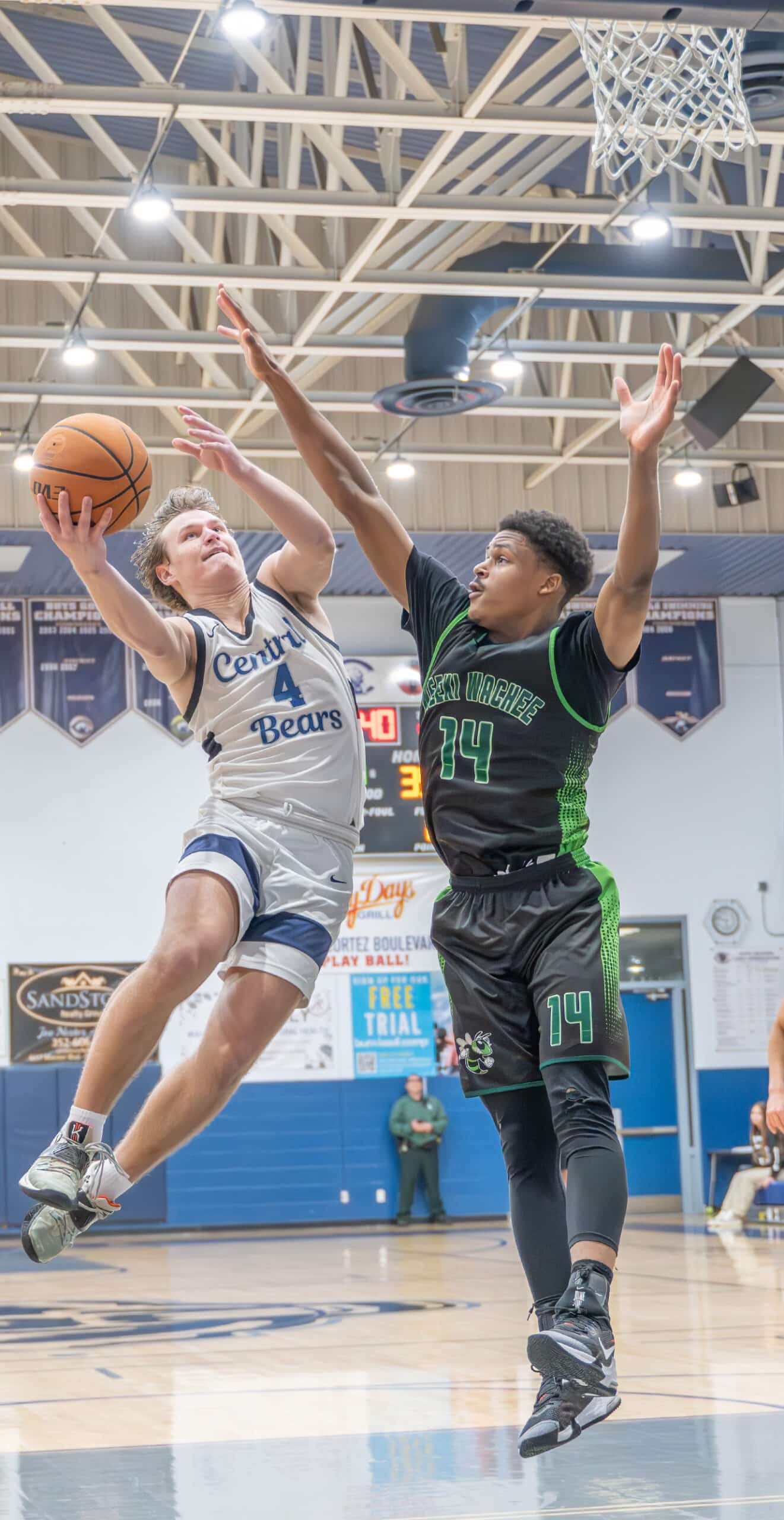 Central High, 4, Braden Joyner works for a layup attempt defended by Weeki Wachee High, 14, Isaac Priester in the 4A District 9 semifinal at Central High Thursday night. [Photo by Joe DiCristofalo]
