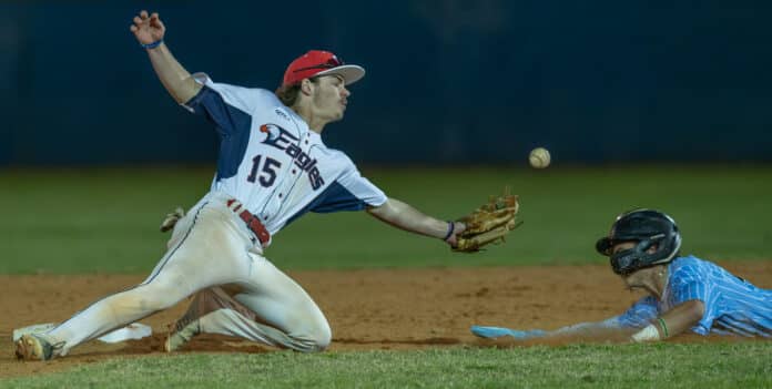 Springstead High, 15, Elijah Sayre could not snare a bouncing throw ahead of the slide by Nature Coast, 7, Jaden Fuentes, Tuesday at Springstead. [Photo by Joe DiCristofalo]