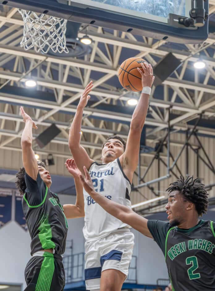 Central High, 21,David Villarroel elevates for a shot while defended by Weeki Wachee High, 1, Jean Garcia and, 2, Alex Wilson in the 4A District 9 semifinal at Central High Thursday night. [Photo by Joe DiCristofalo]