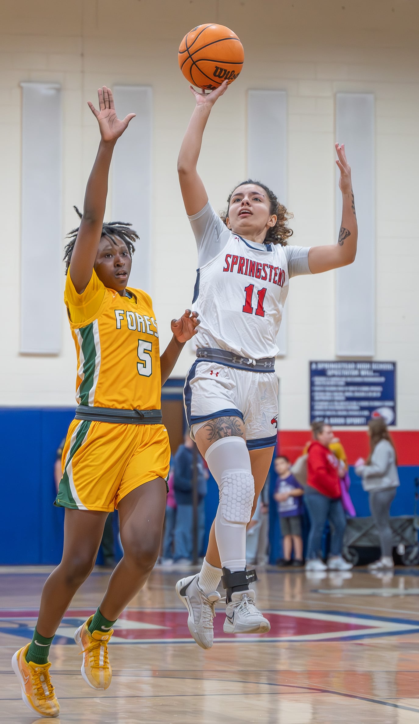 Springstead High School, 11, Samantha Suarez shoots over Forest High defender Janaina Wess, 5, in the 6A Division 4 Championship Game. [Photo by Joe DiCristofalo]