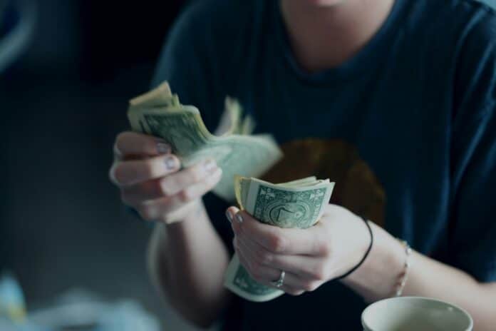 Cash payment. [Photo by Alexander Grey on Unsplash]