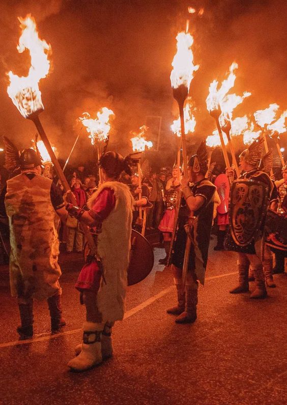 Lerwick locals dressed as Vikings take part in a torchlit procession to the harbor where they will burn a replica Viking longship. 