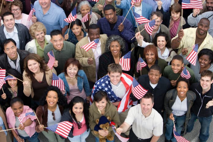 Crowd holding American flags