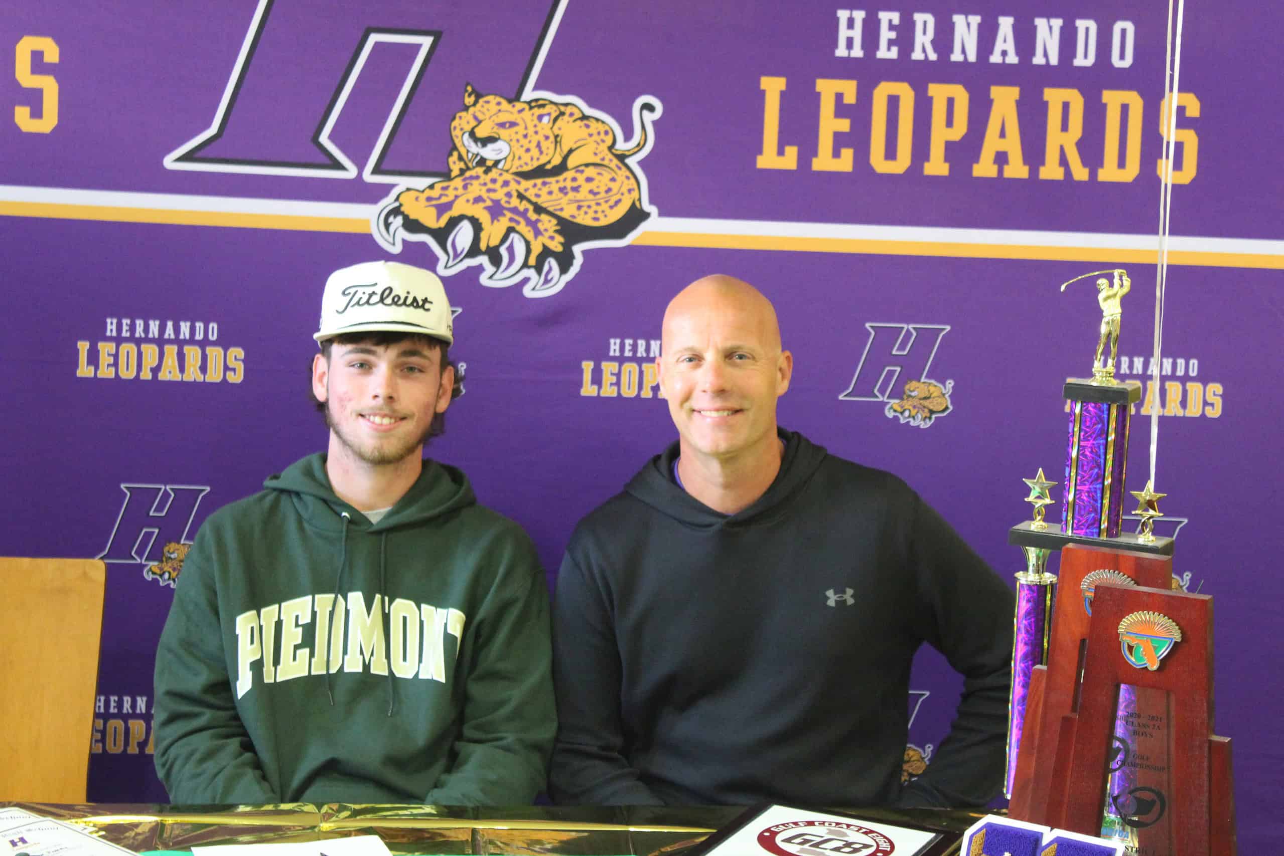 Connor Fahey (left) and Hernando Golf Coach Kevin Bittinger (right) pose for a picture during Connor’s signing ceremony on Tuesday, March 19. [Credit: A. Szempruch]