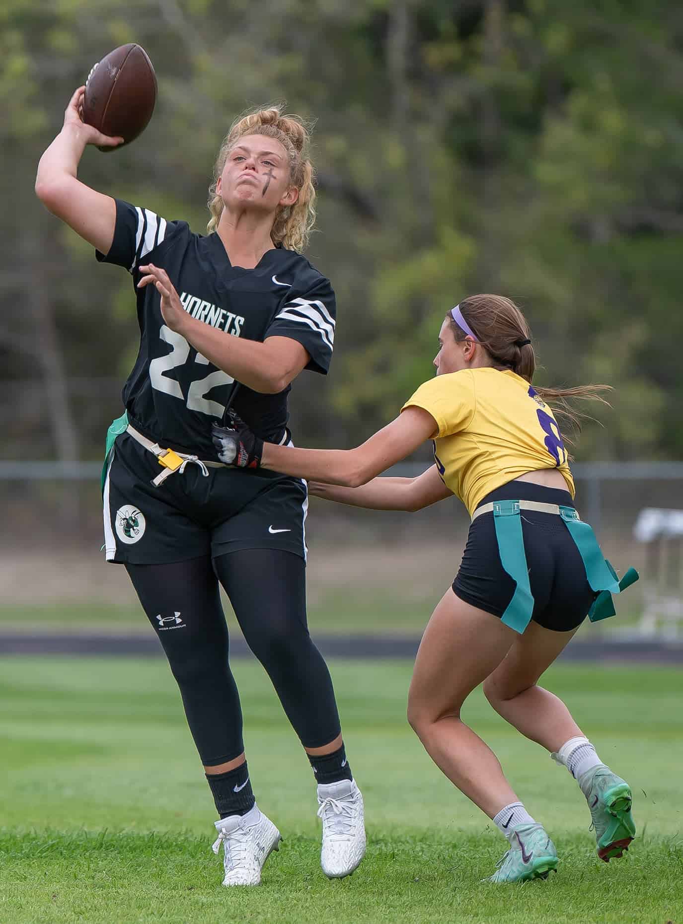 Weeki Wachee, QB, 22, Karly Pasmore avoids the rush by Hernando High, 8, Skyla McCorts Monday at Weeki Wachee High. [Photo by Joe DiCristofalo]