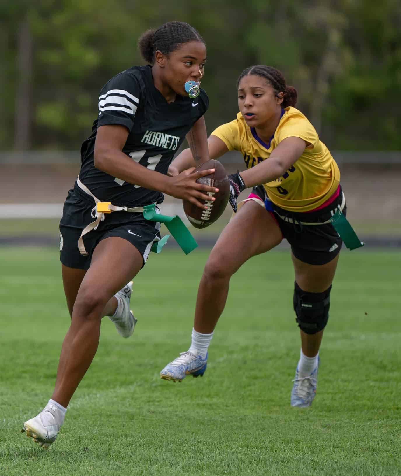 Weeki Wachee, 11, Jasmine Randazzle scrambles while pursued by Hernando High, 6, Elisia Scrivens Monday at Weeki Wachee High. [Photo by Joe DiCristofalo]