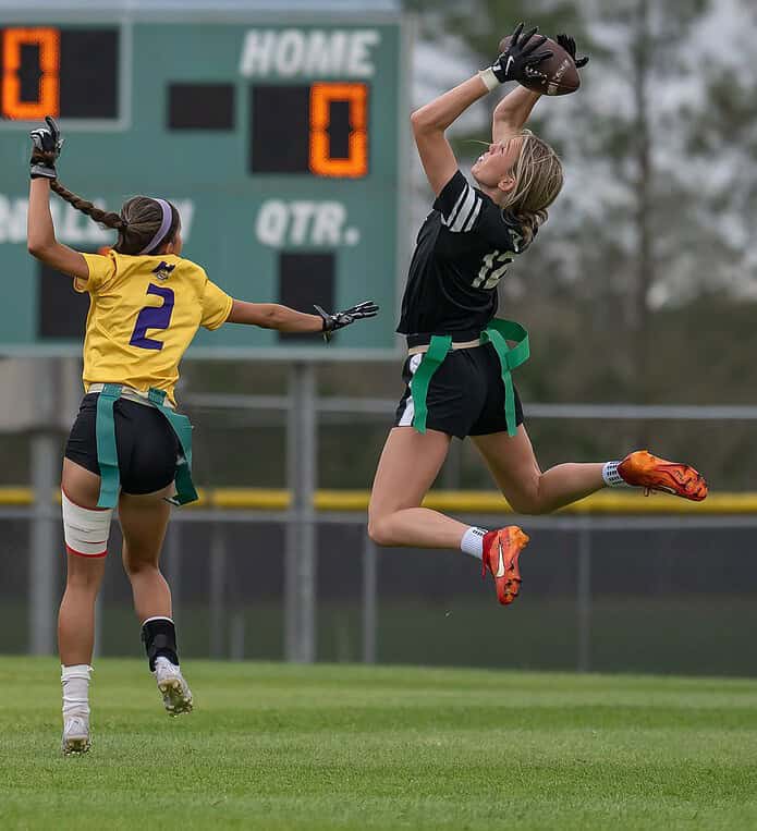 Weeki Wachee, 12, Jillian Aldridge elevates to snare a touchdown pass behind the coverage by Hernando High, 2, Jackie Cuevas Monday at Weeki Wachee High. [Photo by Joe DiCristofalo]